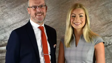 Peter-Stafford-and-Holly-Moxon-from-Cartmell-Shepherd-Solicitors-scaled-e1669402979499.webp