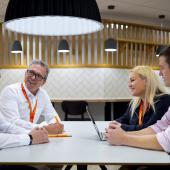 four-EMCOR-UK-colleagues-sitting-in-communal-workspace.jpg