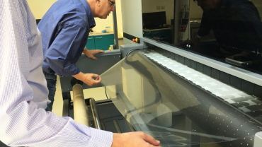 Neil Devery, Signbox's Business Development Manager, inspecting output from the company's new Durst Rho P10 160 UV inkjet printer.