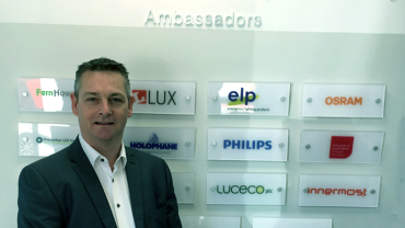 John Williams, Luceco’s Group Specification Director in front of the Wall of Ambassadors.