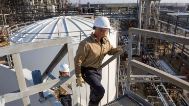 Process Technicians Ricky Bolyard (right) and Samantha Briggs (left) inspect a storm water tank structure in Port Arthur, Texas.