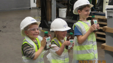 Jan, Lilly and Will proudly show off plan fertiliser fresh from the production line.