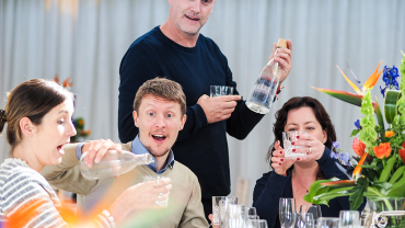 Elmore Court owner Anslem Guise (standing) enjoying Vero Water with friends.