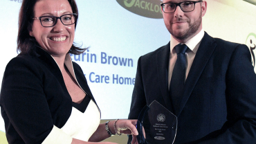 Jackloc founder Emma Wells presents NASHiCS Best Pratice Award to Aneurin Brown of Hallmark Care Homes.
