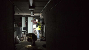 Engineers working on the electrics study the plans.