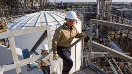 Process Technicians Ricky Bolyard (right) and Samantha Briggs (left) inspect a storm water tank structure in Port Arthur, Texas.