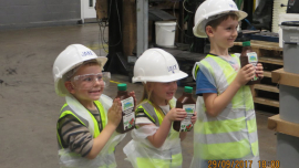 Jan, Lilly and Will proudly show off plan fertiliser fresh from the production line.