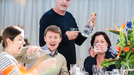 Elmore Court owner Anslem Guise (standing) enjoying Vero Water with friends.
