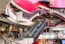 people walking inside building with escalator