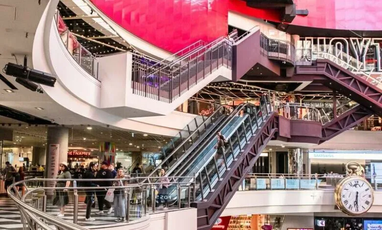 people walking inside building with escalator